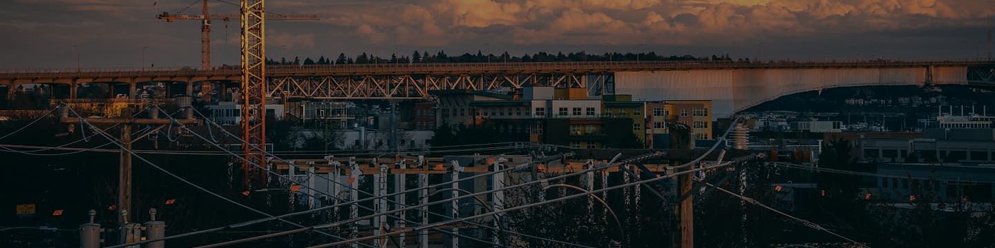Construction cranes at sunset